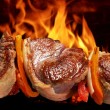 meat on a hot barbecue grill