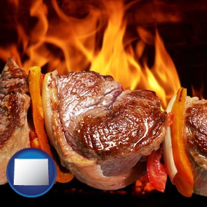 meat on a hot barbecue grill - with Wyoming icon